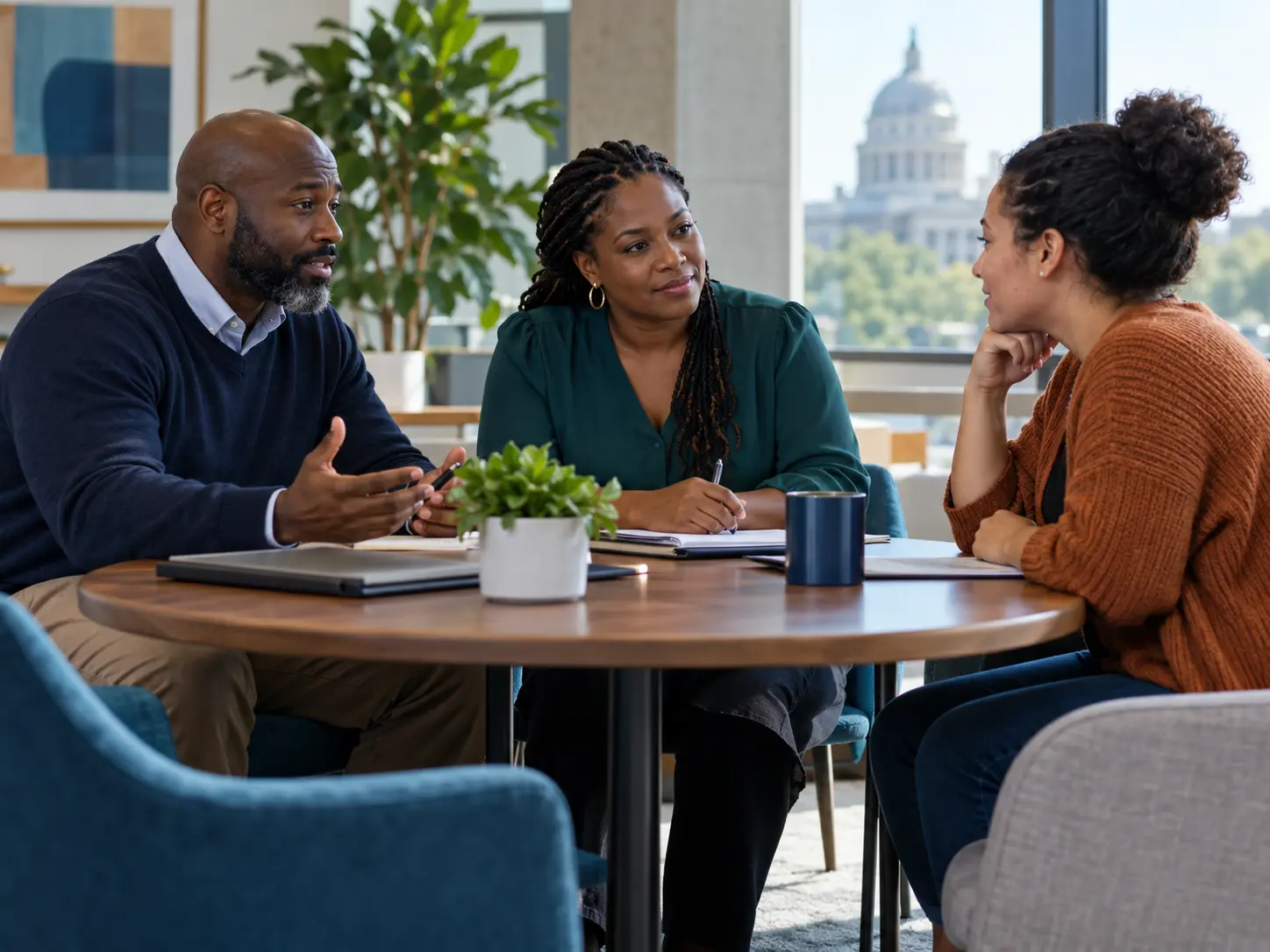 Three adults collaborating around a table on a practical support plan